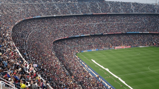 Crowd fills a large football stadium during a FIFA World Cup match.